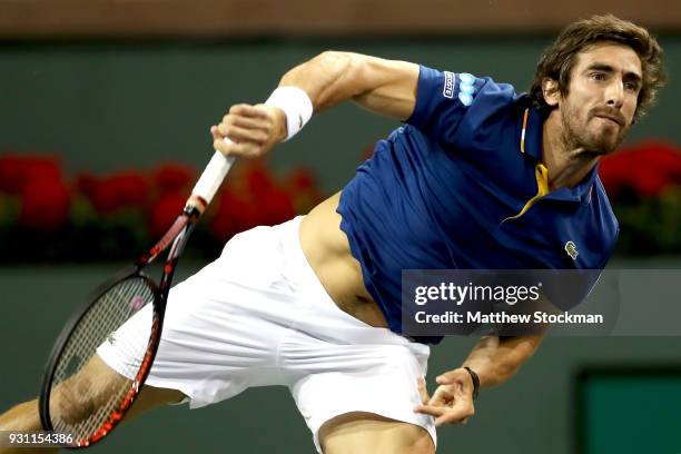 Pablo Cuevas of Uraguay serves to Dominic Thiem of Austria during the BNP Paribas Open at the Indian Wells Tennis Garden on March 12, 2018 in Indian...