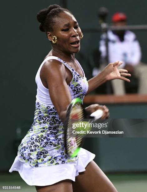Venus Williams of United States hits a forehand agains her sister Serena Williams during Day 8 of BNP Paribas Open on March 12, 2018 in Indian Wells,...