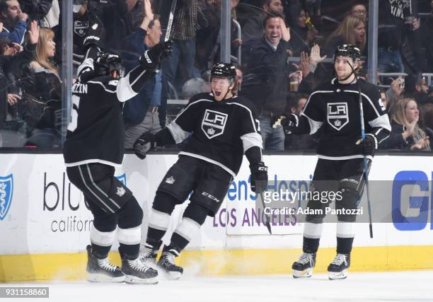 Tyler Toffoli of the Los Angeles Kings celebrates with Jake Muzzin and Adrian Kempe after scoring a goal against the Vancouver Canucks at STAPLES...