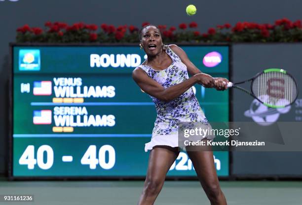 Venus Williams of United States hits a backhand against her sister Serena Williams of United States during Day 8 of BNP Paribas Open on March 12,...