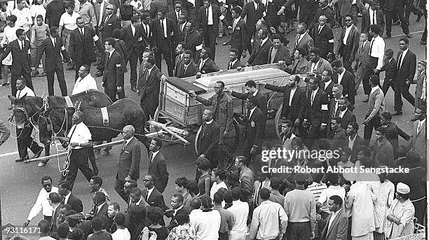 High angle view of the casket of assassinated Civil Rights leader Dr. Martin Luther King Jr., borne on a mule-drawn cart, during a massive funeral...