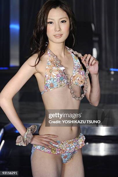 Model displays a bikini swimsuit during a show by Japanese apparel giant Sanai to showcase a swimwear collection for the next season, in Tokyo on...