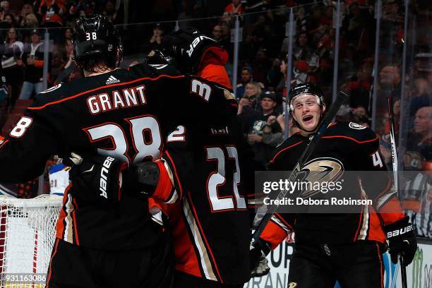 Josh Manson, Derek Grant, and Chris Kelly of the Anaheim Ducks celebrate Grant's goal in the third period of the game against the St. Louis Blues on...