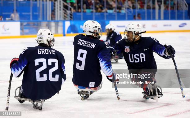 Travis Dodson of United States celebrate with team mate Rico Roman after he scoresa goal of Korea in the Ice Hockey Preliminary Round - Group B game...