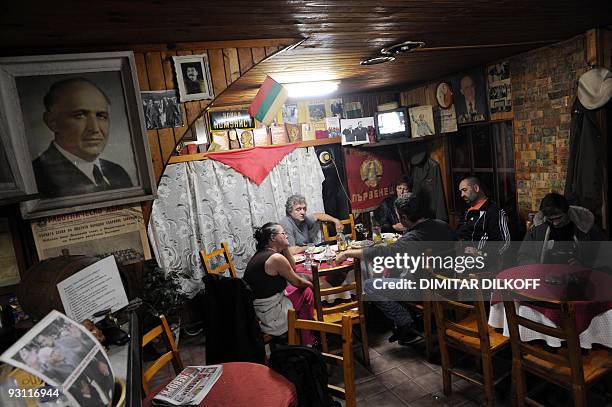 Picture shows people sitting next to portraits of former communist leaders, in a restaurant named after the late Bulgarian communist dictator Todor...