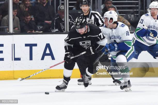 Torrey Mitchell of the Los Angeles Kings battles for the puck against Jake Virtanen of the Vancouver Canucks at STAPLES Center on March 12, 2018 in...