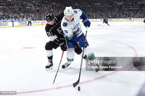 Jake Virtanen of the Vancouver Canucks battles for the puck against Torrey Mitchell of the Los Angeles Kings at STAPLES Center on March 12, 2018 in...