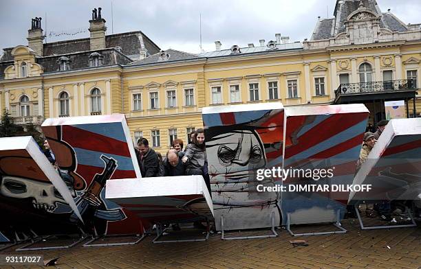 People destroy a wall representing the Berlin Wall on November 9 in the Bulgarian capital Sofia, as part of the celebrations for the 20th anniversary...