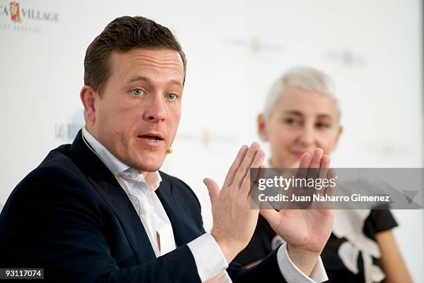 Journalist and blogger Scott Schuman, beside businesswoman Carla Royo Villanova, speaks during a fashion meeting and signing event for his fashion...