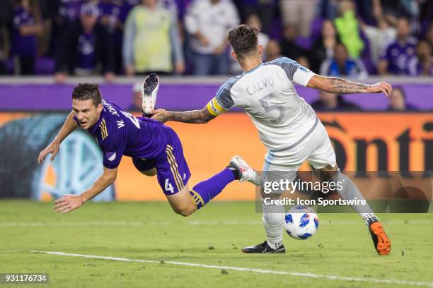 Orlando City midfielder Will Johnson is tripped up by Minnesota United defender Francisco Calvo during the soccer match between The Orlando City...