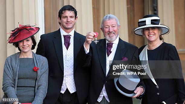 Broadcaster and author John Wilson poses for photographs with his wife Jo , daughter Lisa Tallowin and son Lee Wilson after receiving his MBE for...