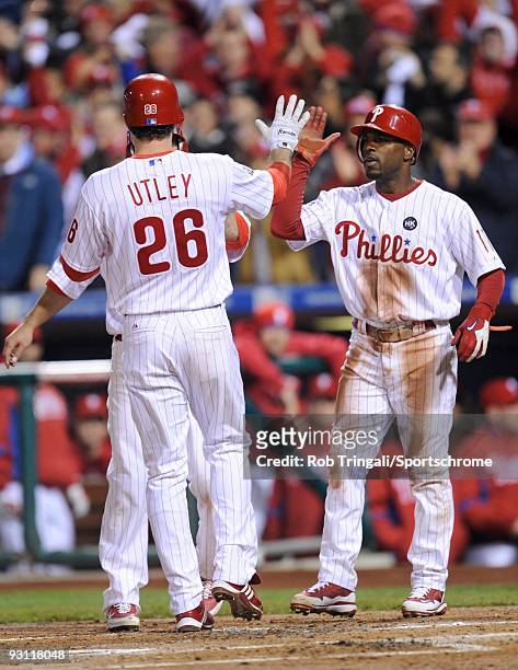 Jimmy Rollins of the Philadelphia Phillies greets Chase Utley after his home run against the New York Yankees in Game Five of the 2009 MLB World...