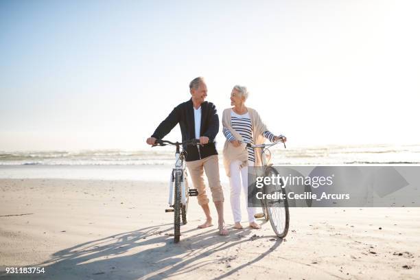 when you retired, everyday is a holiday - couple walking on beach stock pictures, royalty-free photos & images