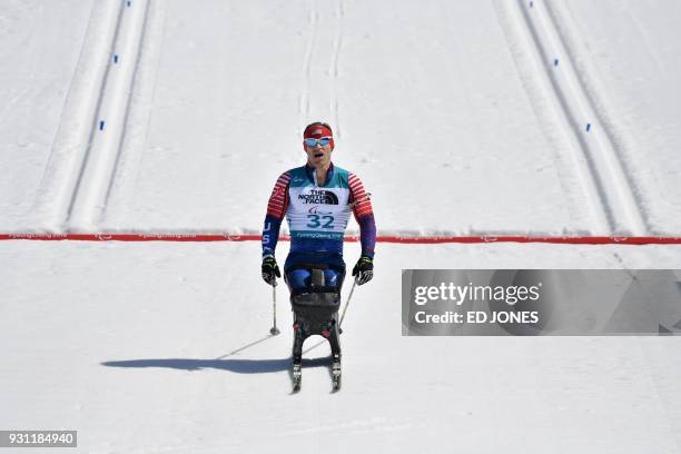 Daniel Cnossen of the US crosses the line to finish second in the men's 12.5km sitting biathlon event at the Alpensia Biathlon Centre during the...