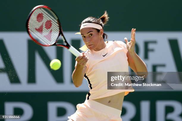 Caroline Garcia of France returns a shot to Daria Gavrilova of Australia during the BNP Paribas Open at the Indian Wells Tennis Garden on March 12,...