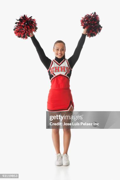 mixed race cheerleader holding pom-poms - pom pom stock-fotos und bilder