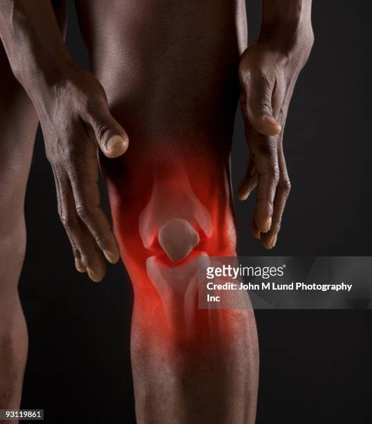 joints of mixed race man's knee - human knee stock pictures, royalty-free photos & images