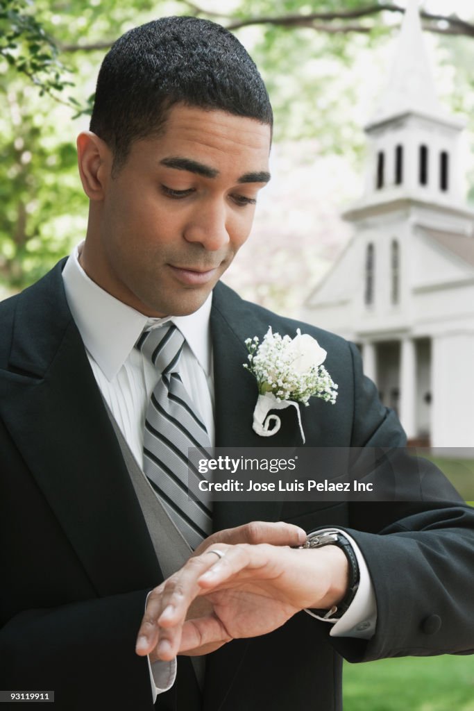 Groom checking wristwatch