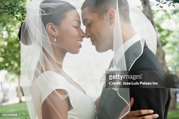bride and groom hugging under veil - wedding veil - fotografias e filmes do acervo