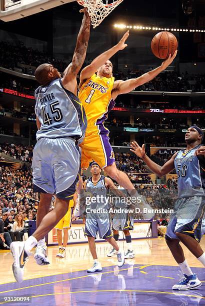 Jordan Farmar of the Los Angeles Lakers goes to the basket under pressure against Steven Hunter of the Memphis Grizzlies during the game on November...