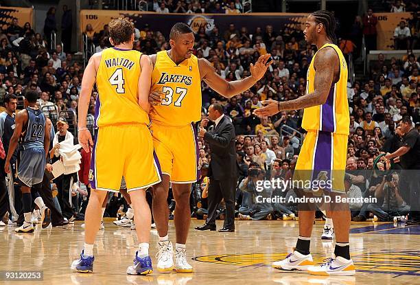 Luke Walton, Ron Artest and Josh Powell of the Los Angeles Lakers celebrate a play against the Memphis Grizzlies during the game on November 6, 2009...