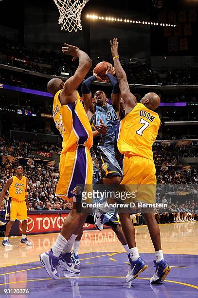 Mayo of the Memphis Grizzlies goes to the basket under pressure against DJ Mbenga and Lamar Odom of the Los Angeles Lakers during the game on...