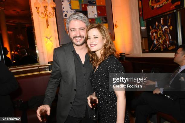 Jeremy Cerrone and Ariane Frier Ferrari attend Marc Cerrone Exhibition Preview at Deux Magots a on March 12, 2018 in Paris, France.