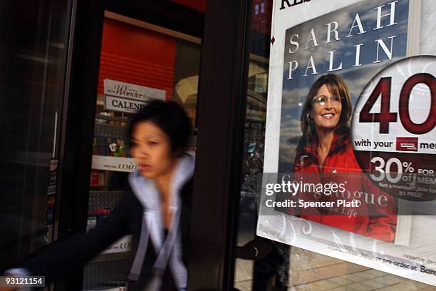 Customer walks out of a Borders book store where a poster for the new book by Sarah Palin is displayed on November 17, 2009 in New York, New York. In...