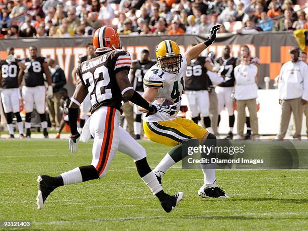 Tight end Spencer Havner of the Green Bay Packers carries the ball after catching a pass as defensive back Brandon McDonald of the Cleveland Browns...