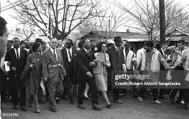 American Civil Rights leader Dr. Martin Luther King Jr. And his wife Coretta Scott King lead others during on the Selma to Montgomery marches held in...