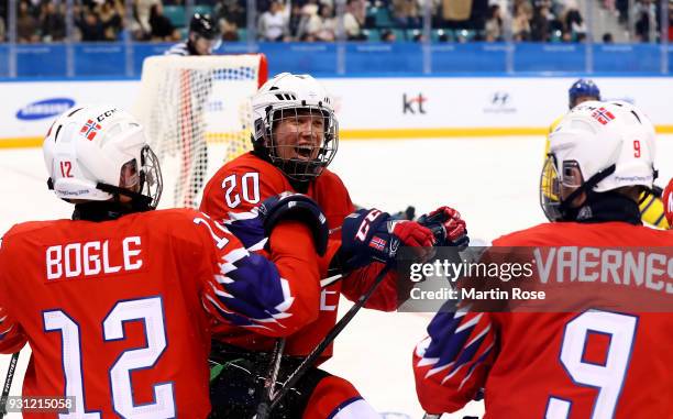 Martin Hamre of Norway celebrate with team mate Magnus Bogle and Morten Vaernes the 2nd goal in the Ice Hockey Preliminary Round - Group A game...