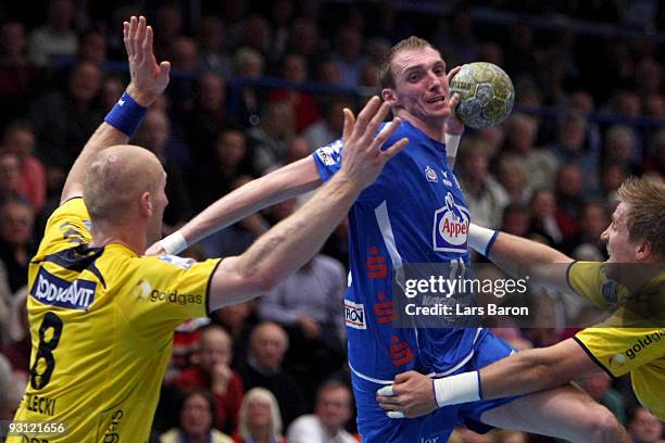 Holger Glandorf of Lemgo is challenged by Karol Bielecki and Oliver Roggisch of Rhein Neckar during the Handball Bundesliga match between TBV Lemgo...