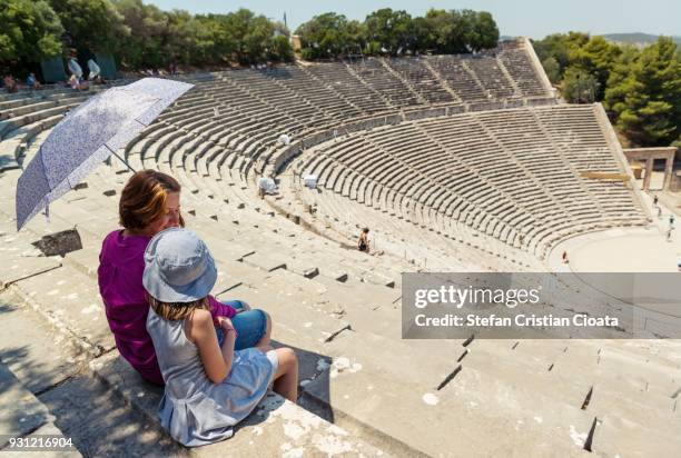 mother and daughter at ancient theater of epidaurus in greece - epidaurus stock pictures, royalty-free photos & images