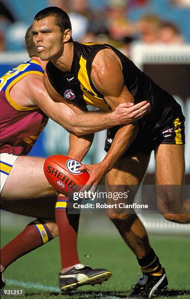 Andrew Kellaway of Richmond is tackled by a Brisbane Lions player, during the AFL round 3 match between, the Richmond Tigers and the Brisbane Lions,...