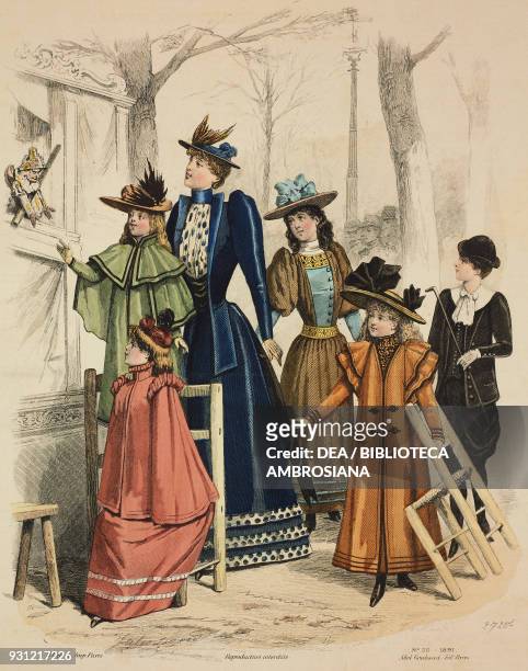 Woman wearing a blue walking dress and hat with feathers along with boys and girls wearing coats and hats arriving at a puppet theatre, Gazette de la...