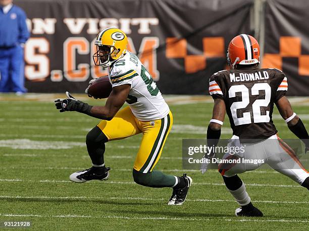 Wide receiver Greg Jennings of the Green Bay Packers carries the ball after catching a pass as defensive back Brandon McDonald of the Cleveland...