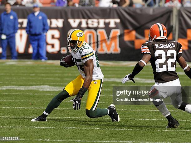 Wide receiver Greg Jennings of the Green Bay Packers carries the ball after catching a pass as defensive back Brandon McDonald of the Cleveland...
