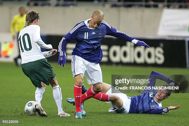 France's forwards Gabriel Obertan and Franck Tabamou vie with Slovenia's forward Kevin Kampl during the Euro 2011 under 21 qualification football...