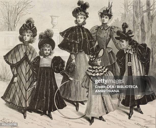 Women wearing a walking dress with cape and striped skirt, woman wearing a walking dress with puffed-sleeves and veil, little girls wearing walking...