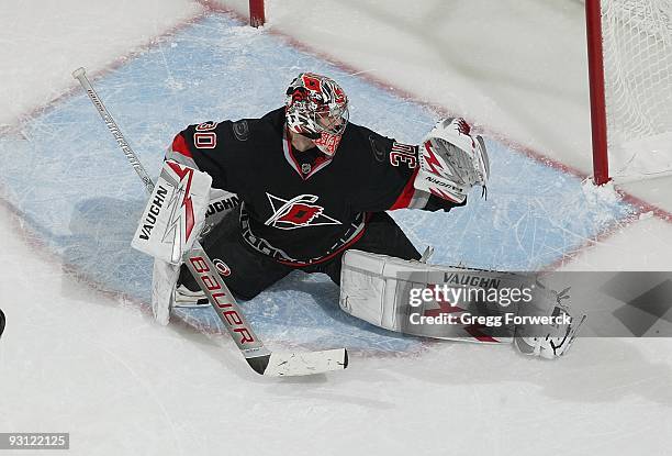 Cam Ward of the Carolina Hurricanes makes a glove save during a NHL game against the Toronto Maple Leafs on November 6, 2009 at RBC Center in...