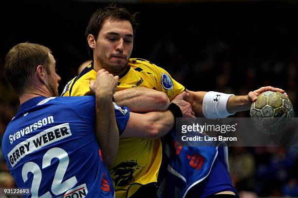 Vignir Svavasson of Lemgo challenges Michael Mueller of Rhein Neckar during the Handball Bundesliga match between TBV Lemgo and Rhein Neckar Loewen...