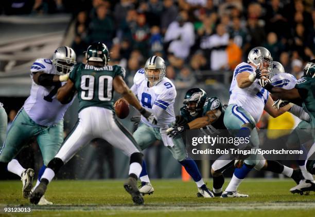 Tony Romo of the Dallas Cowboys tries to escape the rush by Jason Babin of the Philadelphia Eagles at Lincoln Financial Field on November 8, 2009 in...