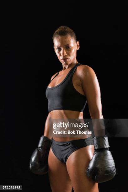 woman boxer, posed waist up, mixed race. - mixed boxing stock-fotos und bilder