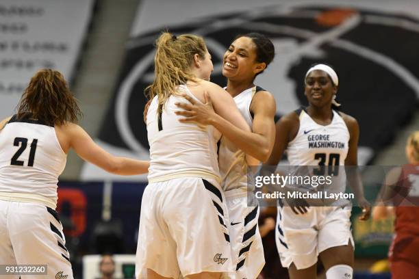 Kelsi Mahoney of the George Washington Colonials celebrates a shot with Breanna Cummings during the Championship game of the Atlantic-10 Women's...