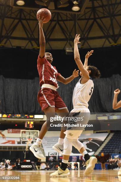 Kristalyn Baisden of the St. Joseph's Hawks drives to the basket over Brianna Cummings of the George Washington Colonials during the Championship...