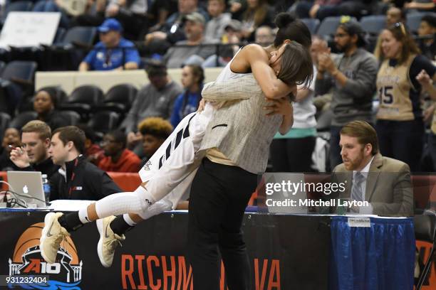 Head coach Jennifer Rizzotti of the George Washington Colonials hugs Breanna Cummings during the Championship game of the Atlantic-10 Women's...