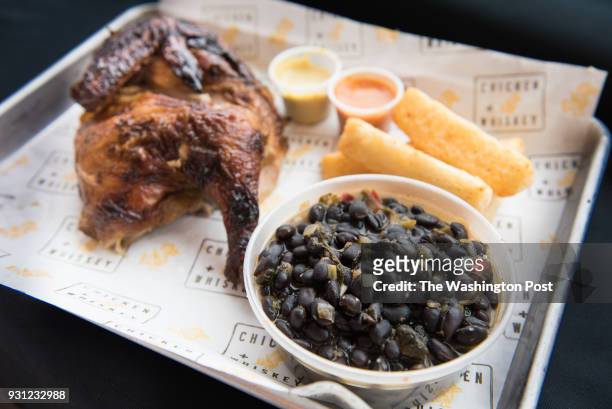 Pollo A La Brasa - South American rotisserie chicken with yuca fries & black beans at Chicken Whiskey in Washington, DC on March 8, 2018.