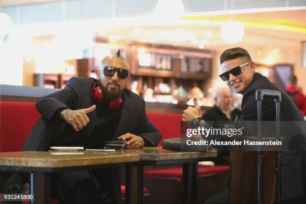 Arturo Vidal of FC Bayern Muenchen arrives with his team mate James Rodriquez at Munich international airport 'Franz Josef Strauss' prior their team...