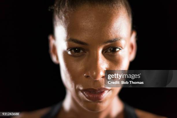 portrait of a mixed race woman following a gym work out - determination face stock pictures, royalty-free photos & images