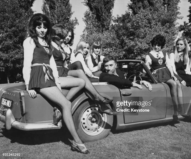 English comic actor Frankie Howerd with some of the actresses from the film 'The Great St Trinian's Train Robbery' at Shepperton Studios, UK, 4th...